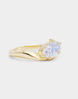 Oval diamond in a curvy sculpture smooth gold band. Dune - oval lab diamond