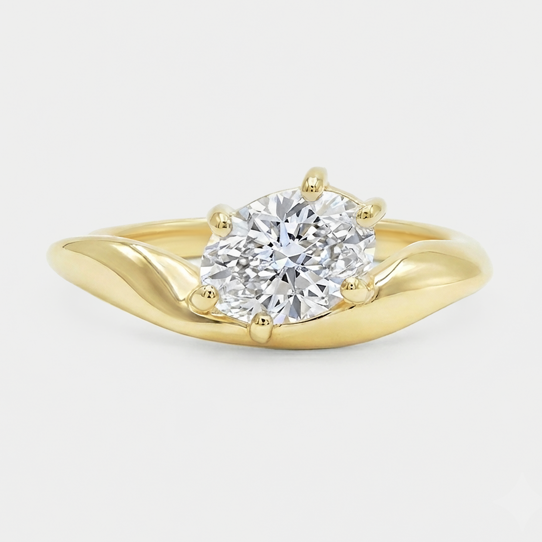 Oval diamond in a curvy sculpture smooth gold band. Dune - oval lab diamond