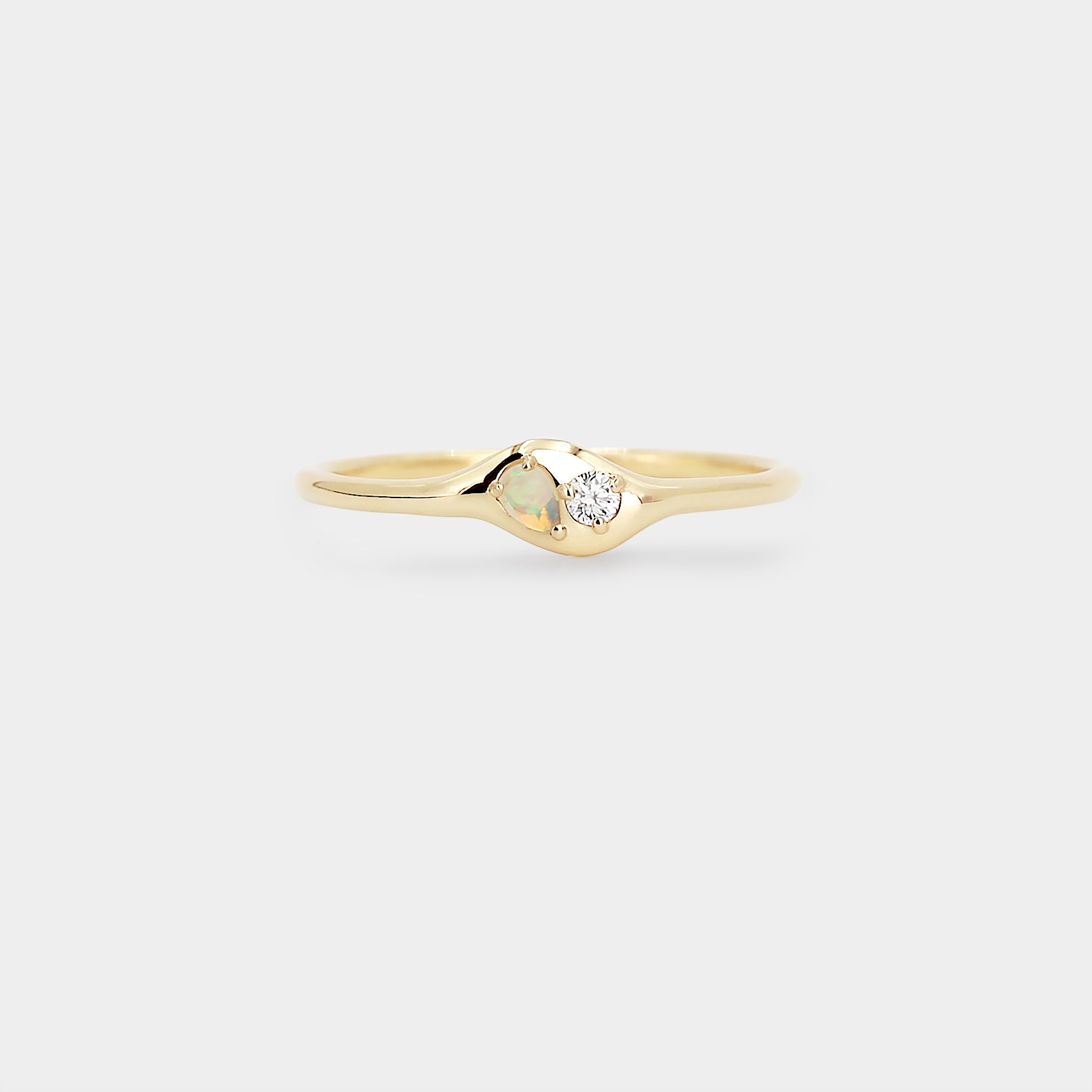 Gold ring with a small diamond  and a pear Australian opal