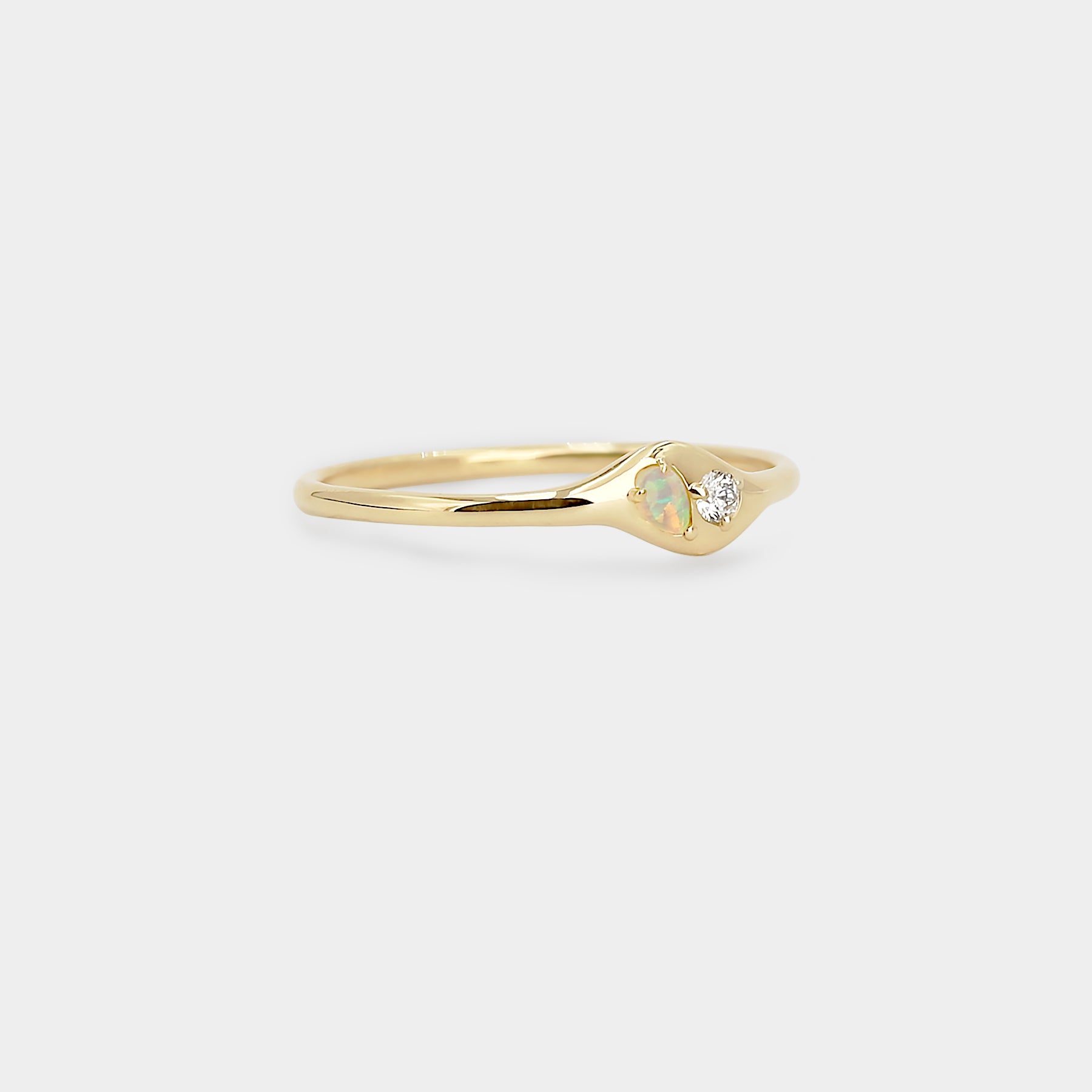 Gold ring with a small diamond and a pear Australian opal