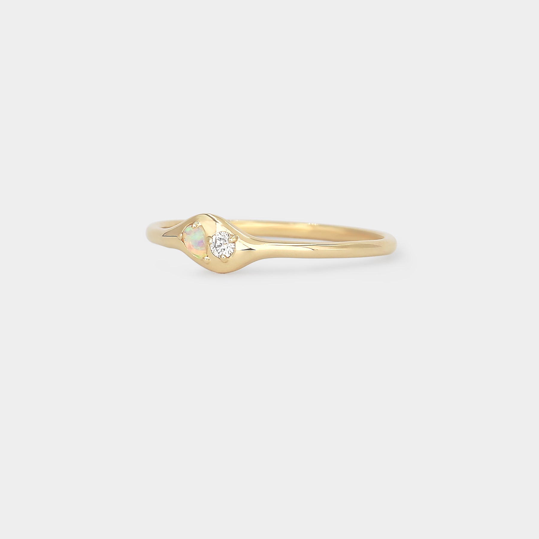 Gold ring with a small diamond and a pear Australian opal