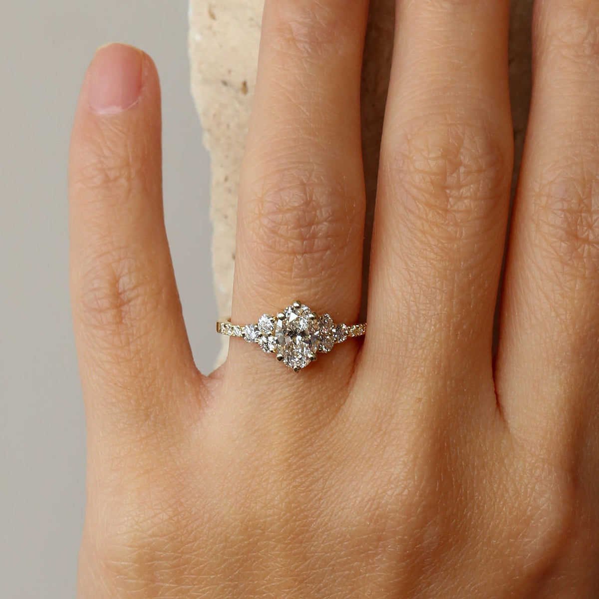 Cluster oval diamond ring on hand - James and Irisa